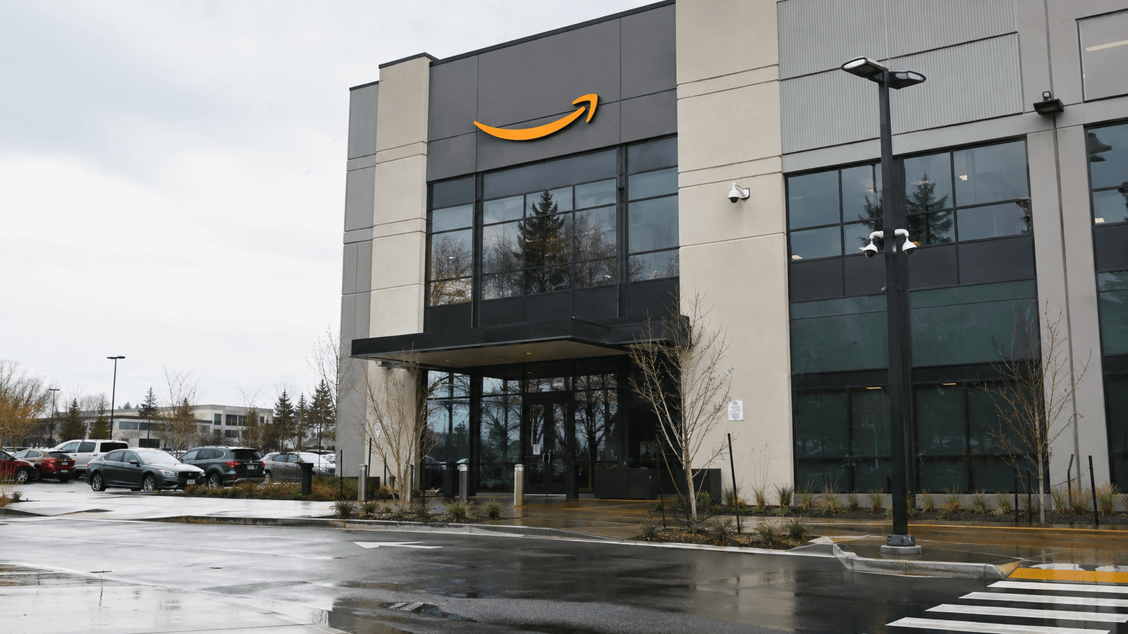 Illustrative exterior of a modern Amazon technology facility on a rainy day
